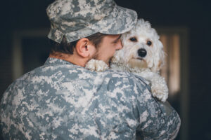 Soldier greeting his cute white dog after long time